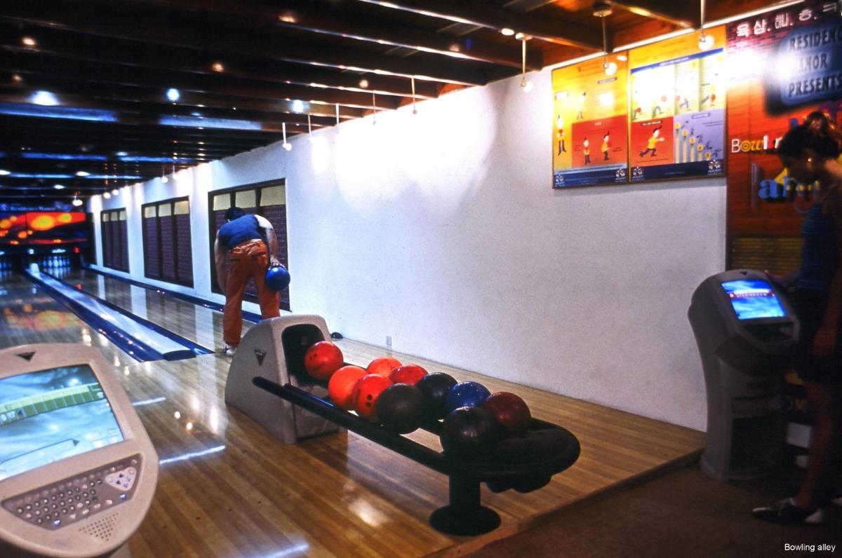 a man playing a game of bowling in a bowling alley at Jaypee Residency Manor in Mussoorie