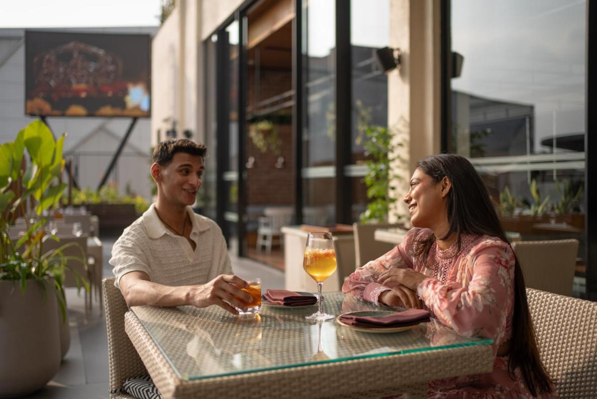 a man and a woman sitting at a table at Hyatt Centric MG Road Bangalore in Bengaluru a man and a woman sitting at a table at Hyatt Centric MG Road Bangalore in Bengaluru