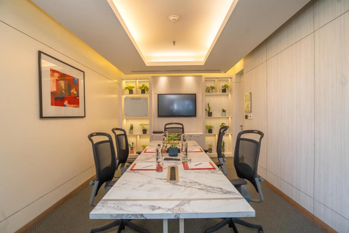 a conference room with a long table and chairs at Hyatt Centric MG Road Bangalore in Bengaluru a conference room with a long table and chairs at Hyatt Centric MG Road Bangalore in Bengaluru