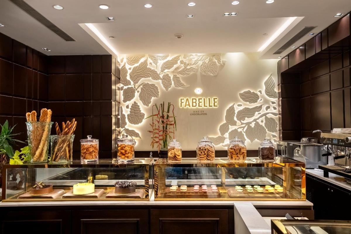 a bakery counter with pastries and other food items at ITC Maurya, a Luxury Collection Hotel, New Delhi in New Delhi a bakery counter with pastries and other food items at ITC Maurya, a Luxury Collection Hotel, New Delhi in New Delhi