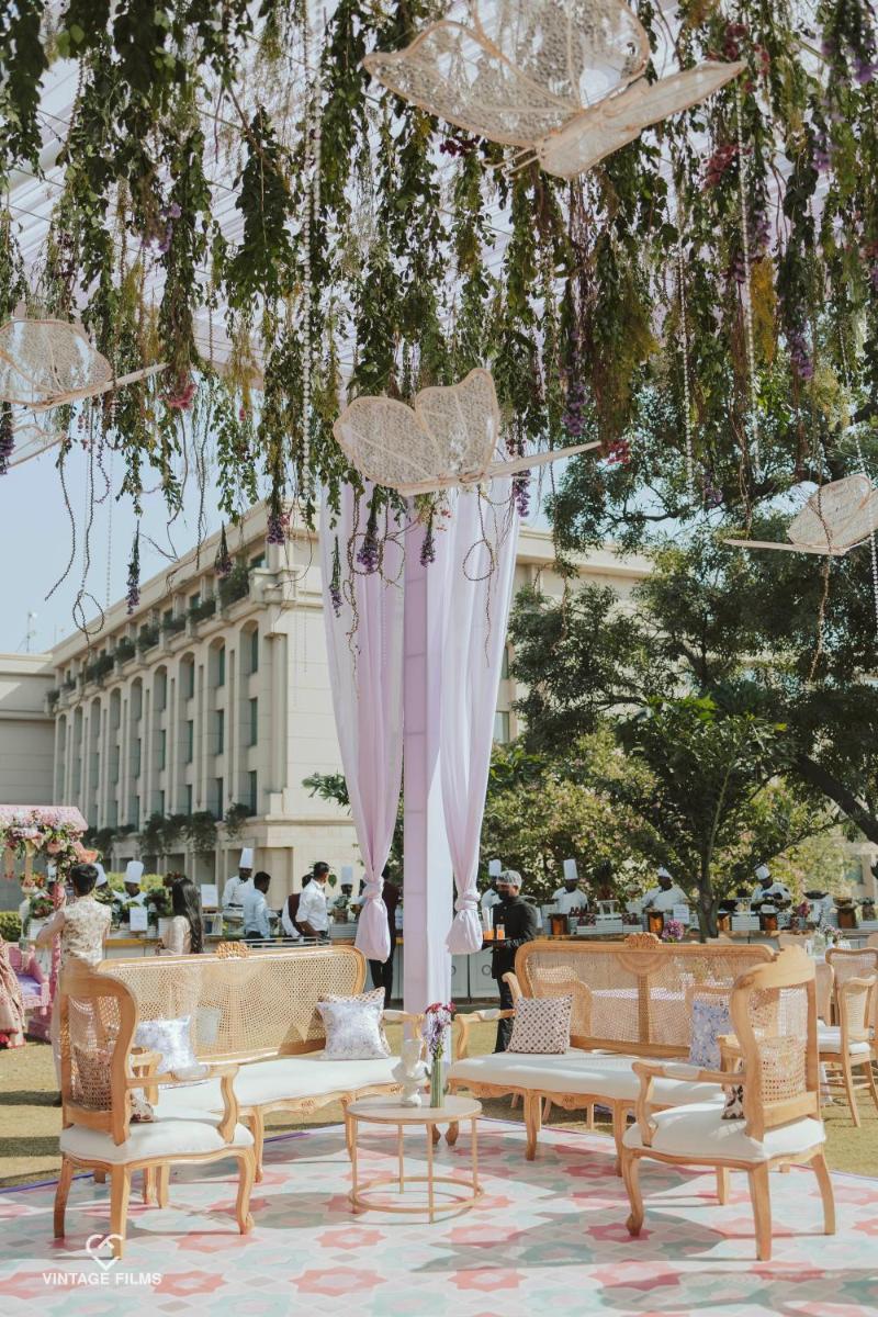 a group of chairs and umbrellas in a park at The Grand New Delhi in New Delhi a group of chairs and umbrellas in a park at The Grand New Delhi in New Delhi