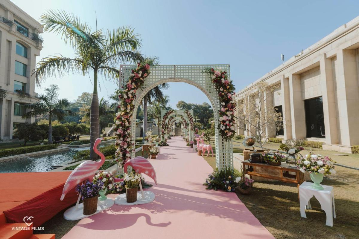 an archway with flowers and a pink table cloth at The Grand New Delhi in New Delhi an archway with flowers and a pink table cloth at The Grand New Delhi in New Delhi