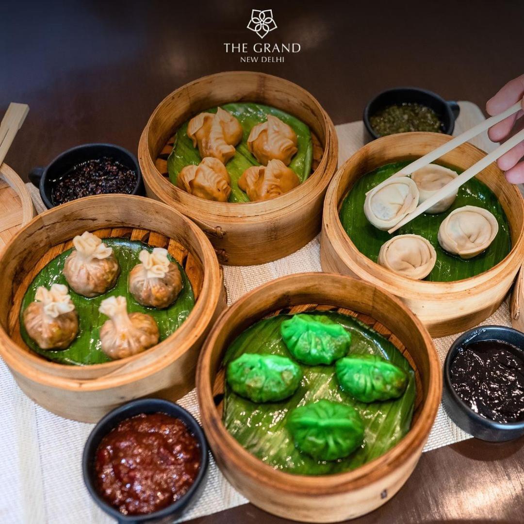 a group of four wooden bowls filled with food at The Grand New Delhi in New Delhi a group of four wooden bowls filled with food at The Grand New Delhi in New Delhi