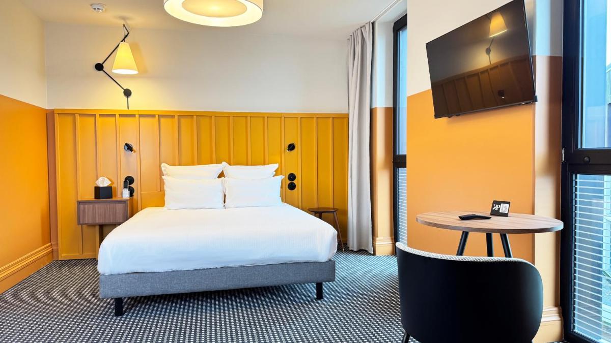 Un ou plusieurs lits dans un hébergement de l'établissement Kyriad Prestige Compiègne Hotel & Spa