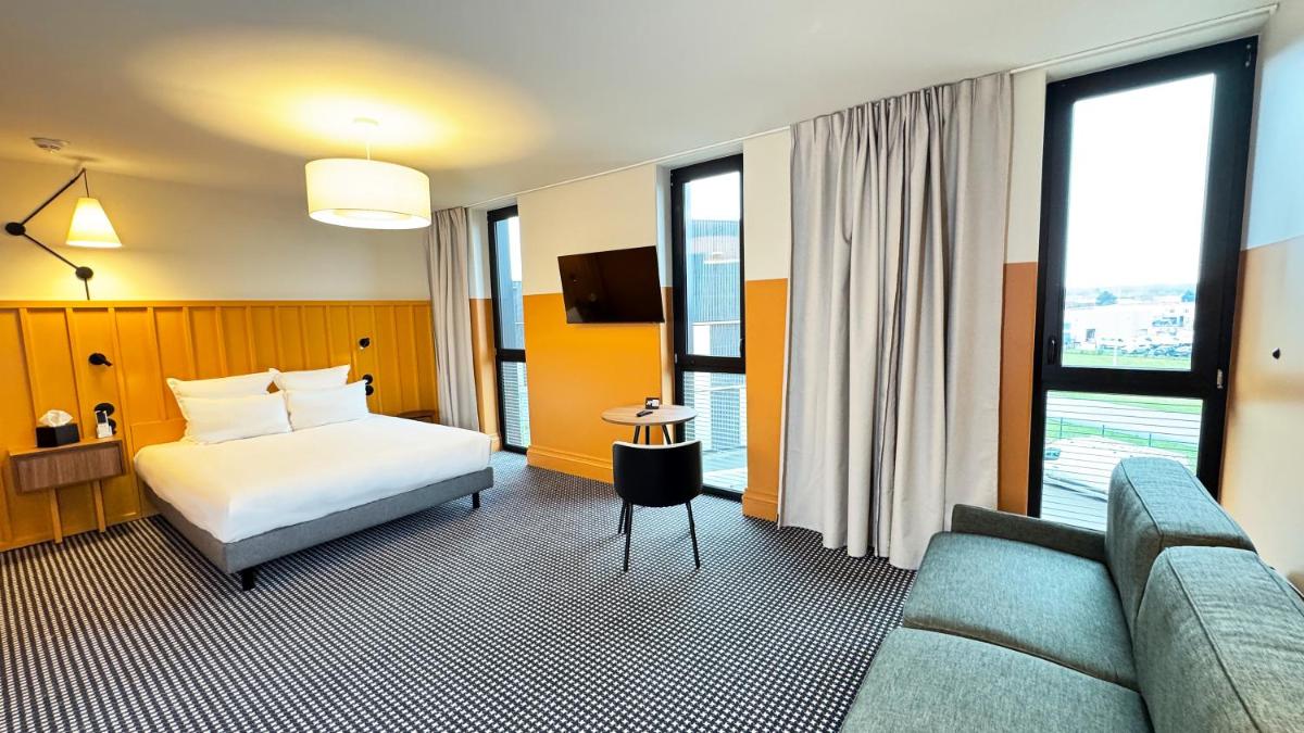 Un ou plusieurs lits dans un hébergement de l'établissement Kyriad Prestige Compiègne Hotel & Spa