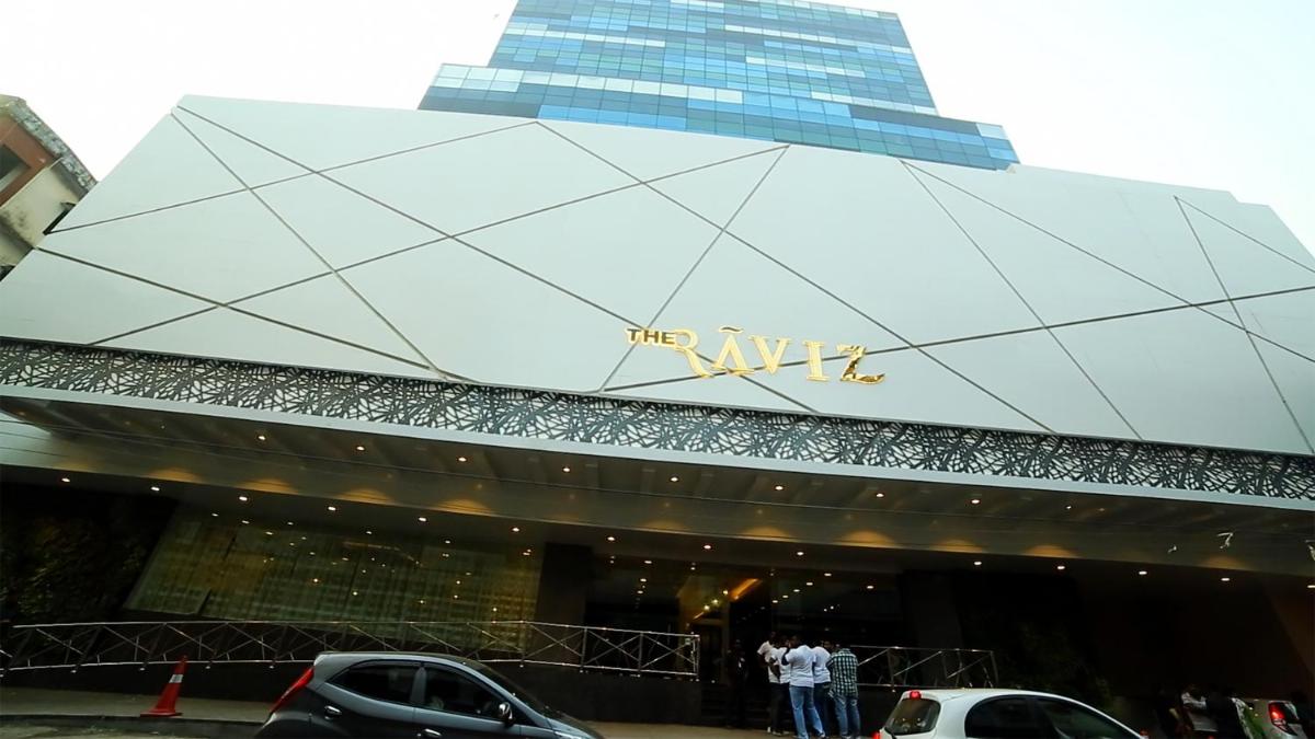 a group of people standing outside of a building at The Raviz Calicut in Kozhikode