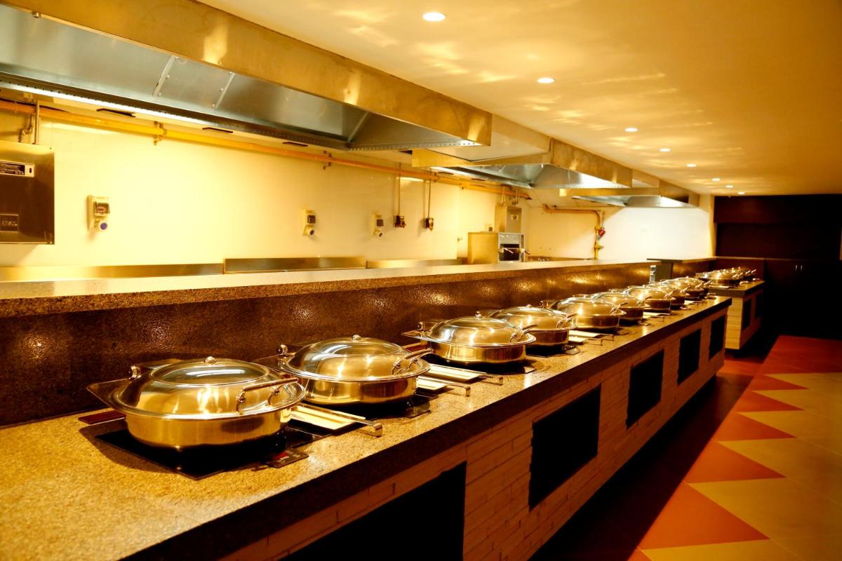a row of pots and pans in a kitchen at The Raviz Calicut in Kozhikode