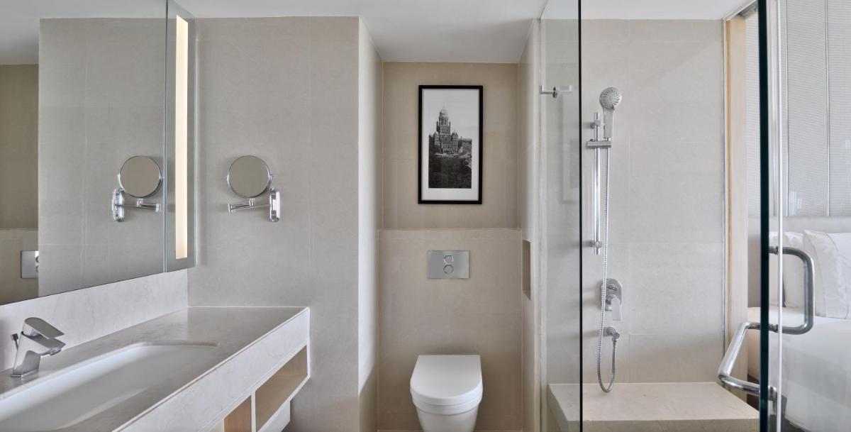 a bathroom with a sink and a toilet and a shower at The Westin Mumbai Powai Lake in Mumbai