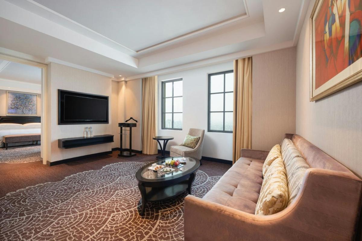 a large living room with a couch and a television at ITC Royal Bengal, a Luxury Collection Hotel, Kolkata in Kolkata