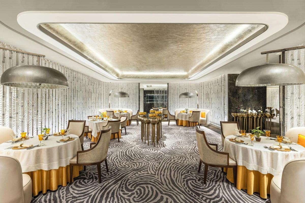 a rendering of a restaurant with tables and chairs at ITC Royal Bengal, a Luxury Collection Hotel, Kolkata in Kolkata