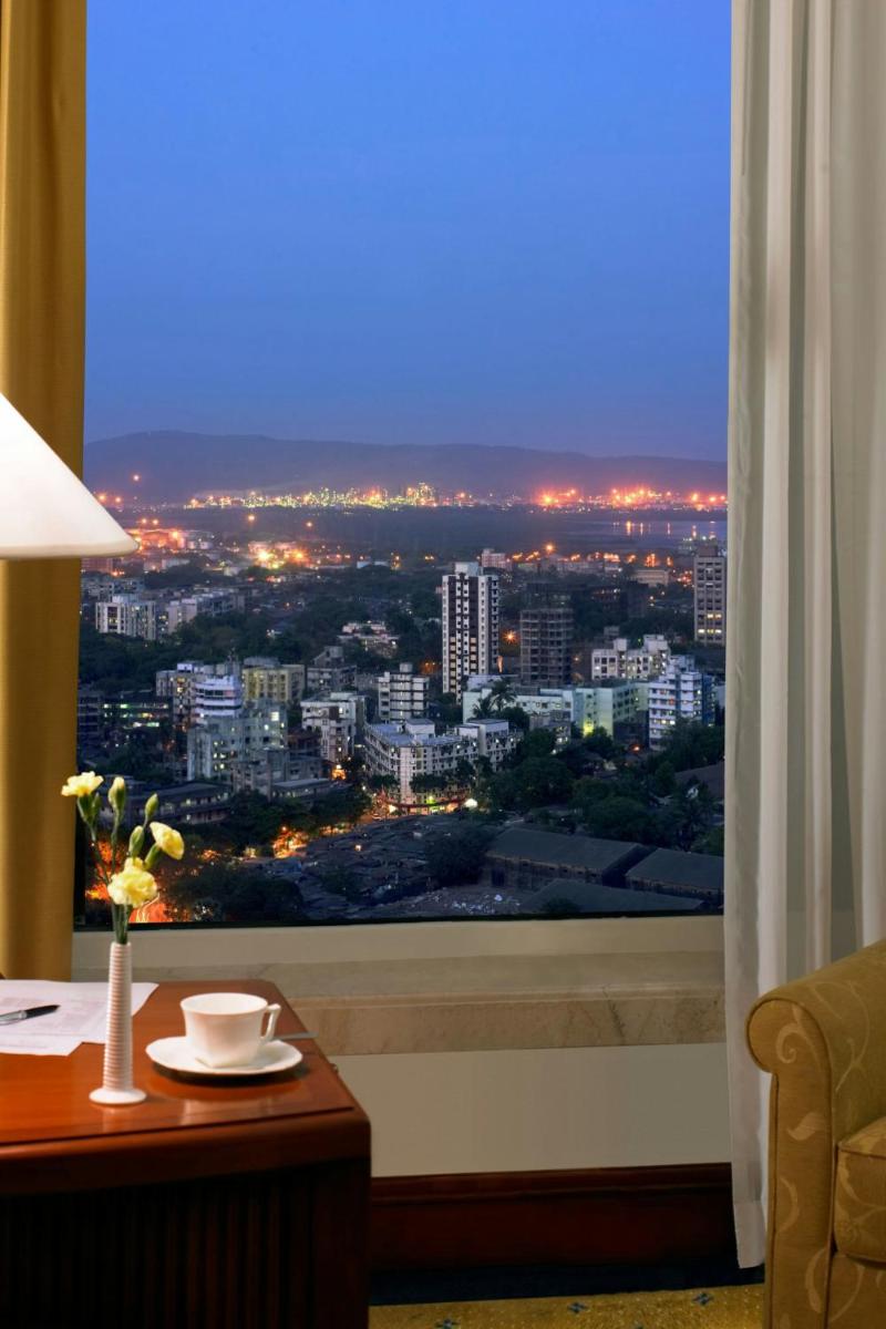 a room with a window with a view of a city at ITC Grand Central, a Luxury Collection Hotel, Mumbai in Mumbai