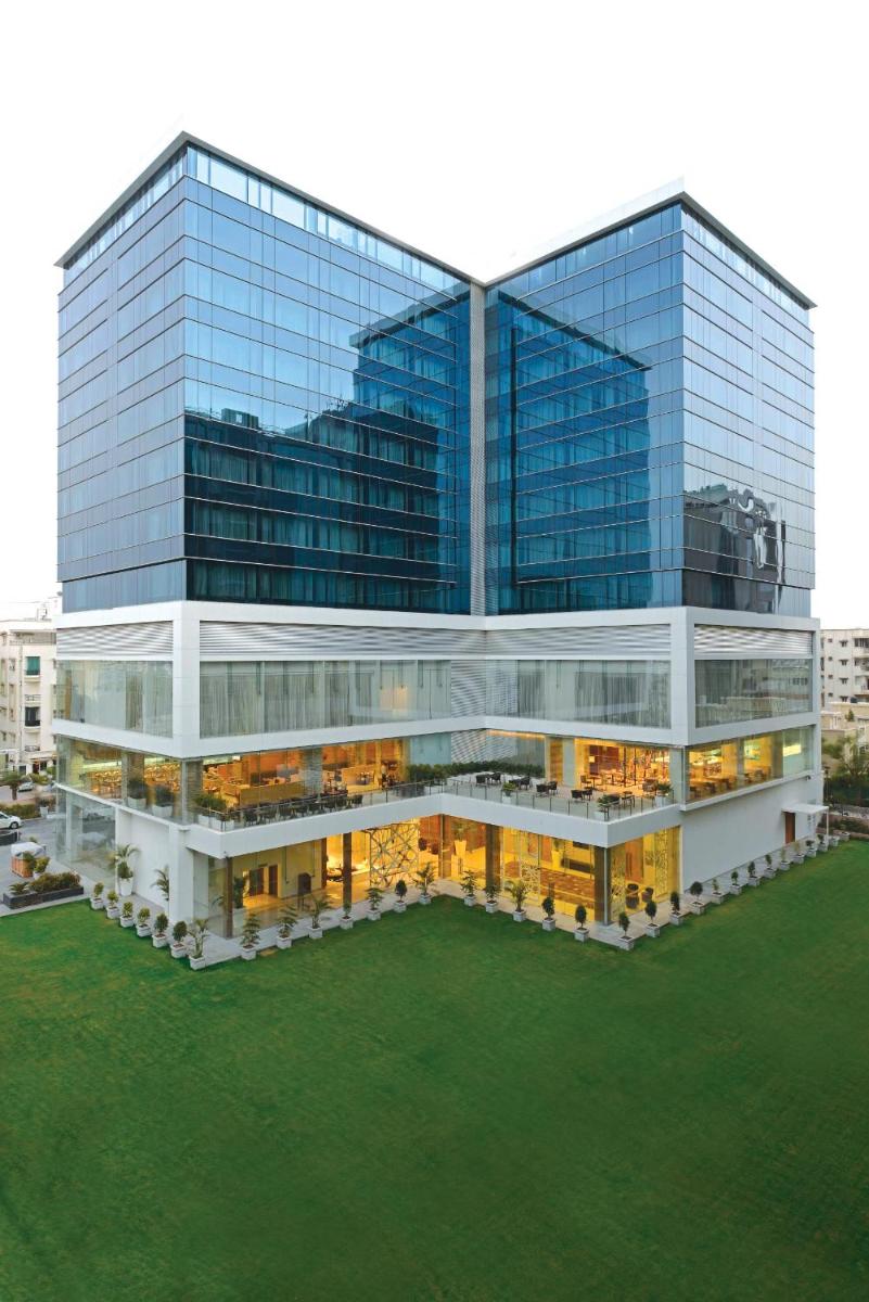 a large glass office building with a lot of windows at Renaissance Ahmedabad Hotel in Ahmedabad