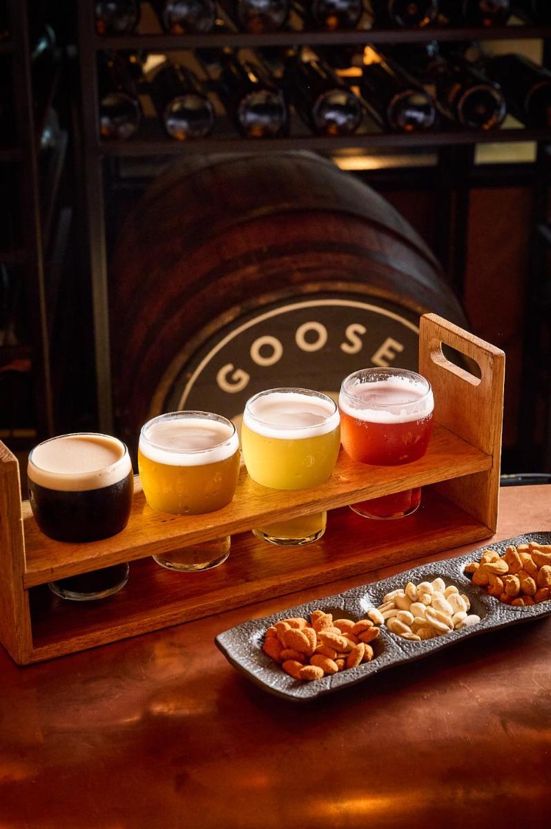 a wooden tray with different types of food on a table at FIVE Jumeirah Village in Dubai