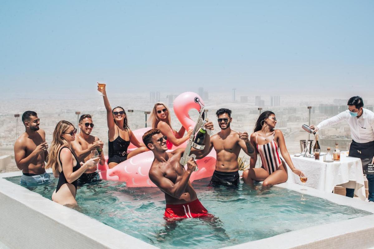 a group of people in the water at a pool at FIVE Jumeirah Village in Dubai