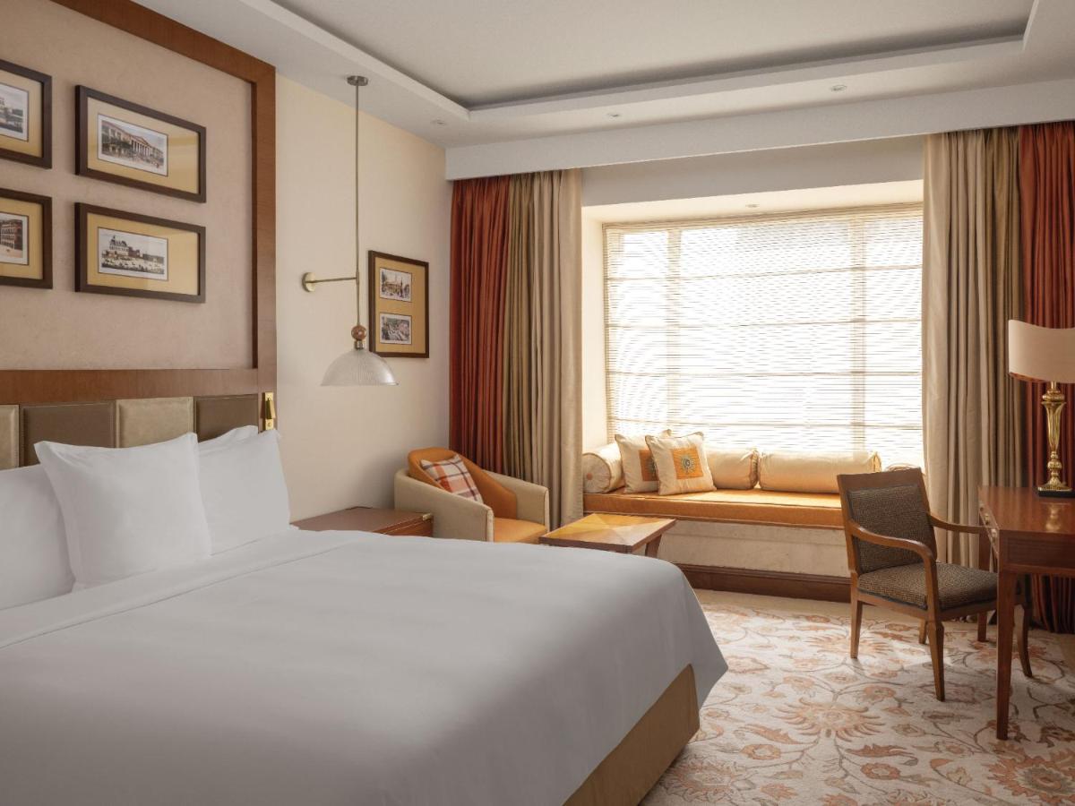 a hotel room with a bed and a desk at ITC Grand Central, a Luxury Collection Hotel, Mumbai in Mumbai