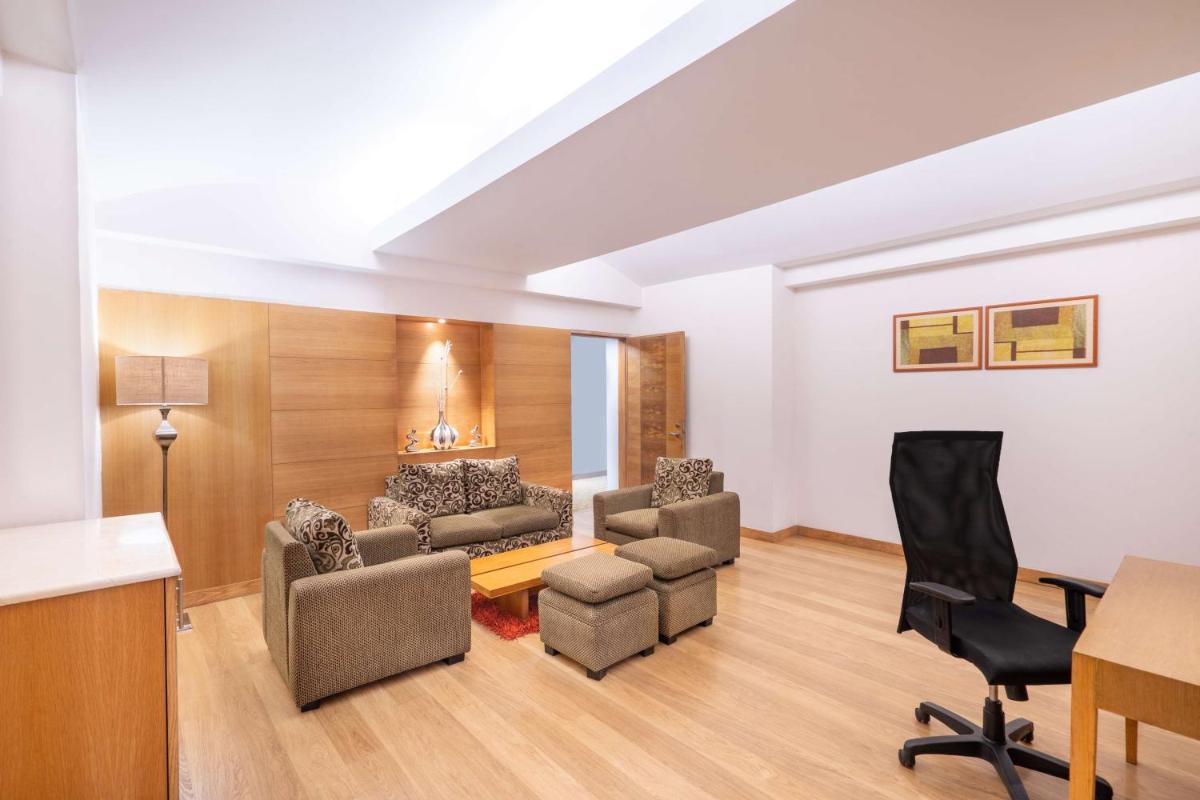 a living room with a couch and chairs at Park Plaza Chennai OMR in Chennai
