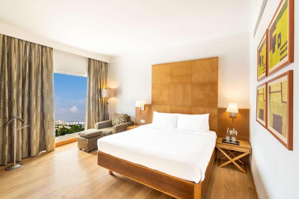 a hotel room with a bed and a large window at Park Plaza Chennai OMR in Chennai