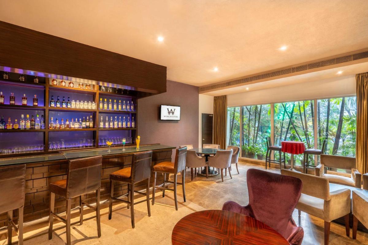 a bar in a restaurant with chairs and tables at Park Plaza Chennai OMR in Chennai