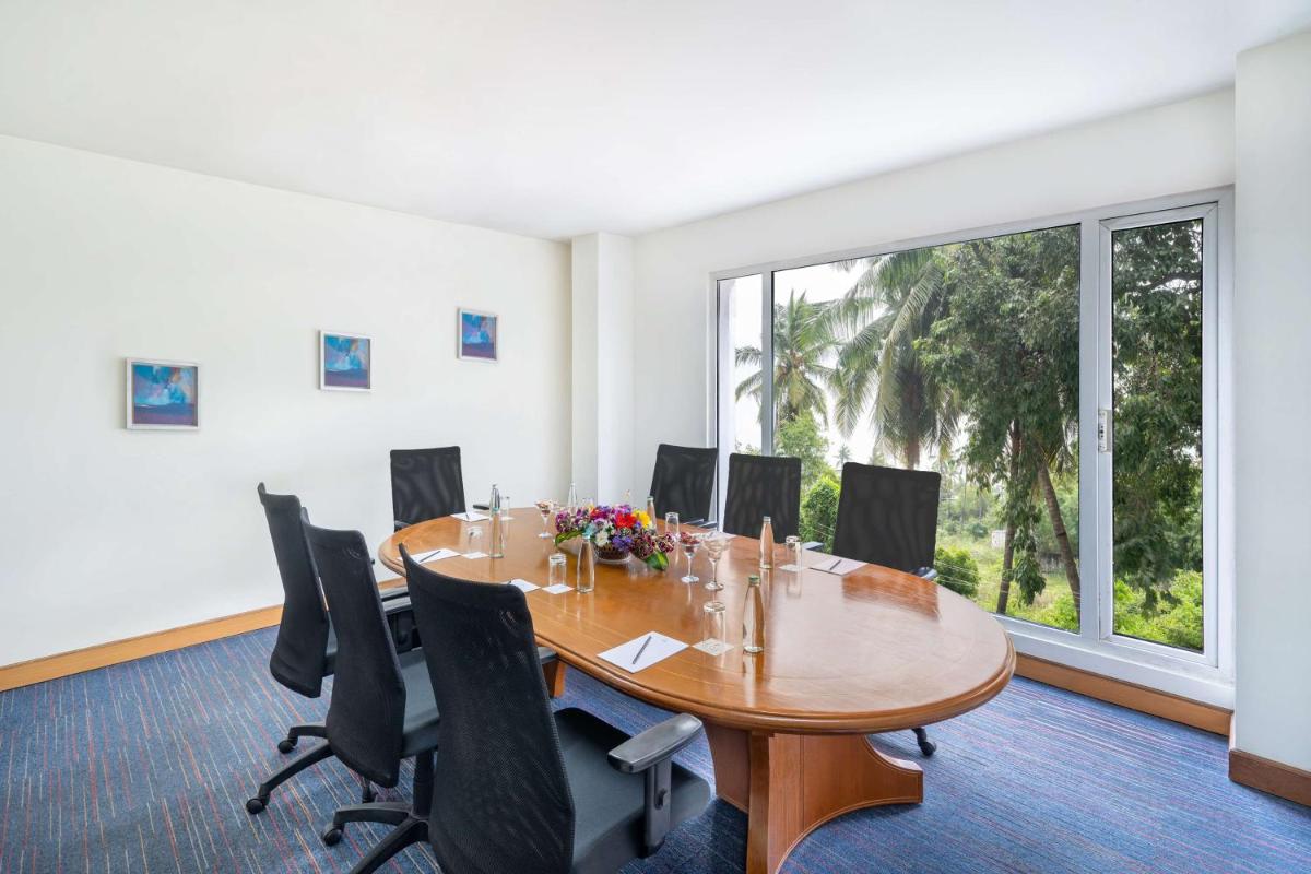 a conference room with a table and chairs and a large window at Park Plaza Chennai OMR in Chennai