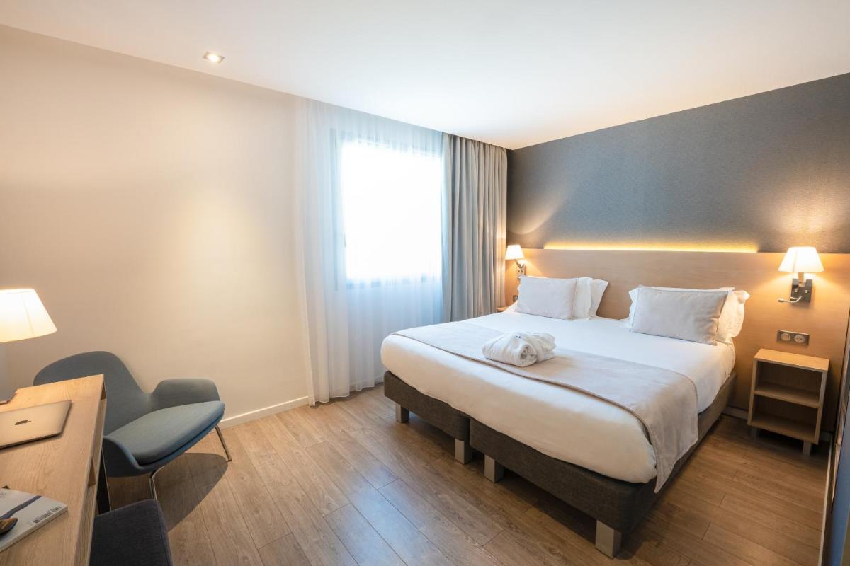 Un ou plusieurs lits dans un hébergement de l'établissement Golden Tulip Sophia Antipolis - Hotel & Spa