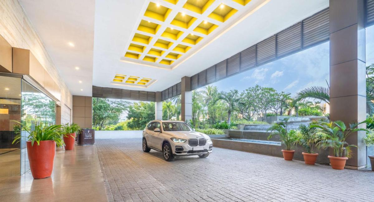 a small car parked inside of a building with plants at Park Plaza Chennai OMR in Chennai