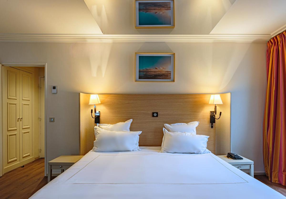 Un ou plusieurs lits dans un hébergement de l'établissement Grand Tonic Hotel & SPA NUXE