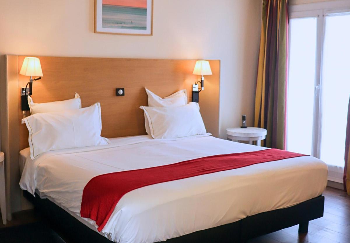 Un ou plusieurs lits dans un hébergement de l'établissement Grand Tonic Hotel & SPA NUXE