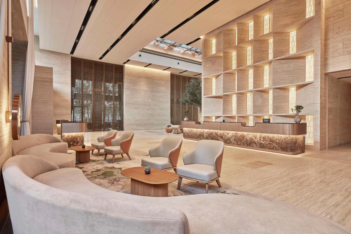 a lobby with chairs and a waiting room at Hilton Gurugram Baani City Centre in Gurgaon