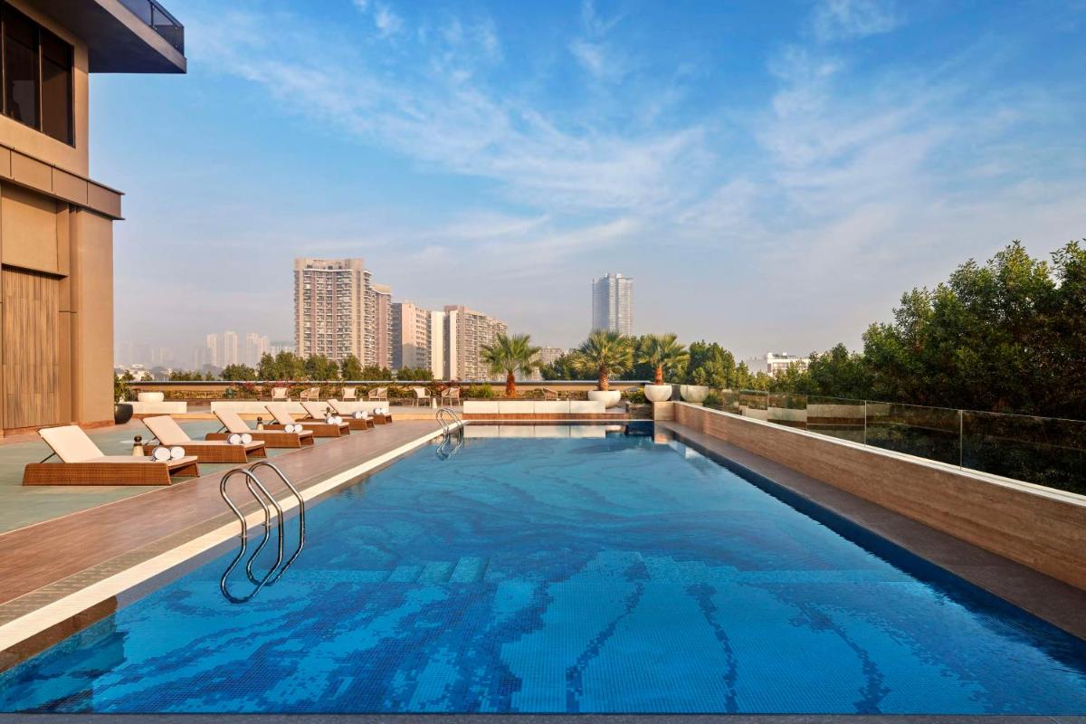 a swimming pool on the roof of a building at Hilton Gurugram Baani City Centre in Gurgaon