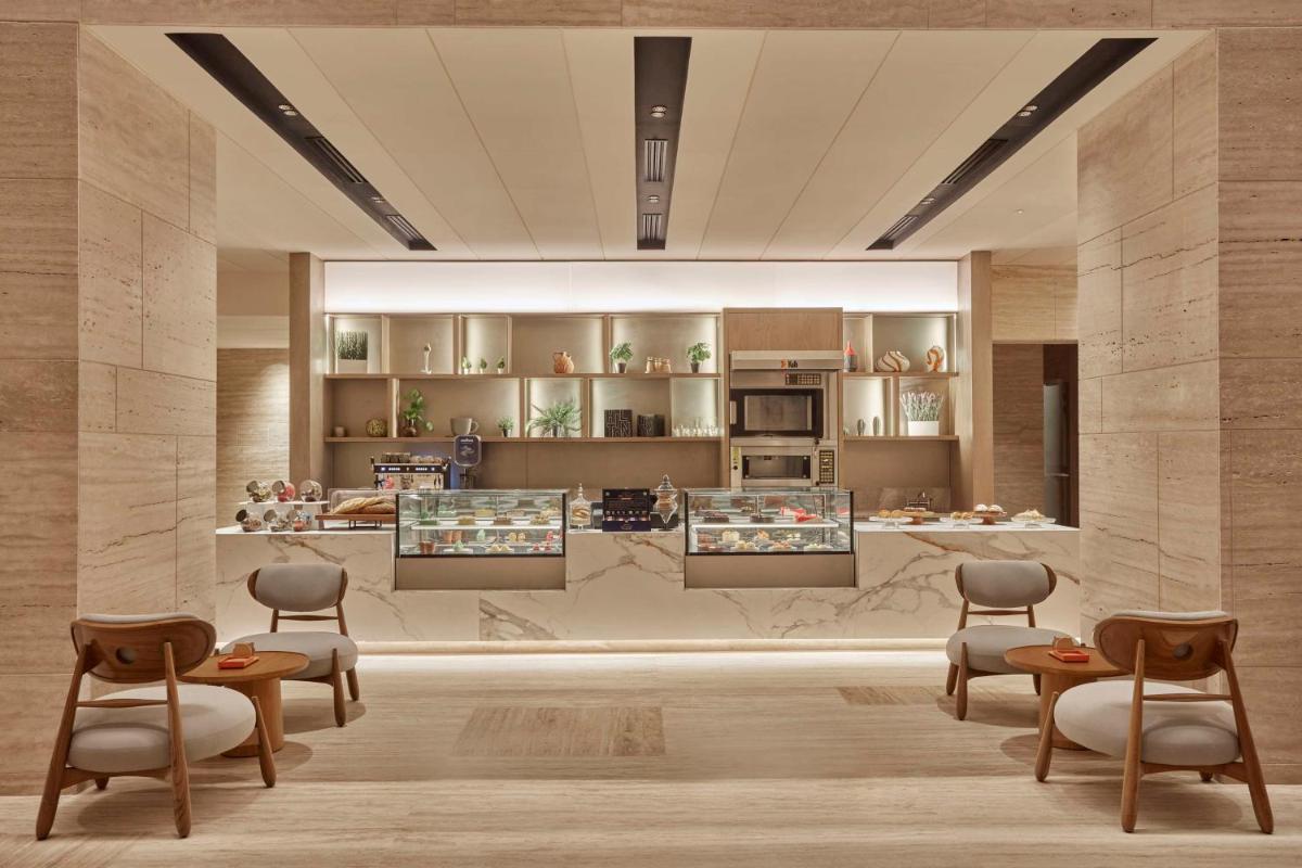 a rendering of a kitchen with chairs and tables at Hilton Gurugram Baani City Centre in Gurgaon