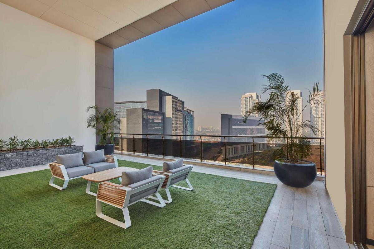 a balcony with a view of a city skyline at Hilton Gurugram Baani City Centre in Gurgaon