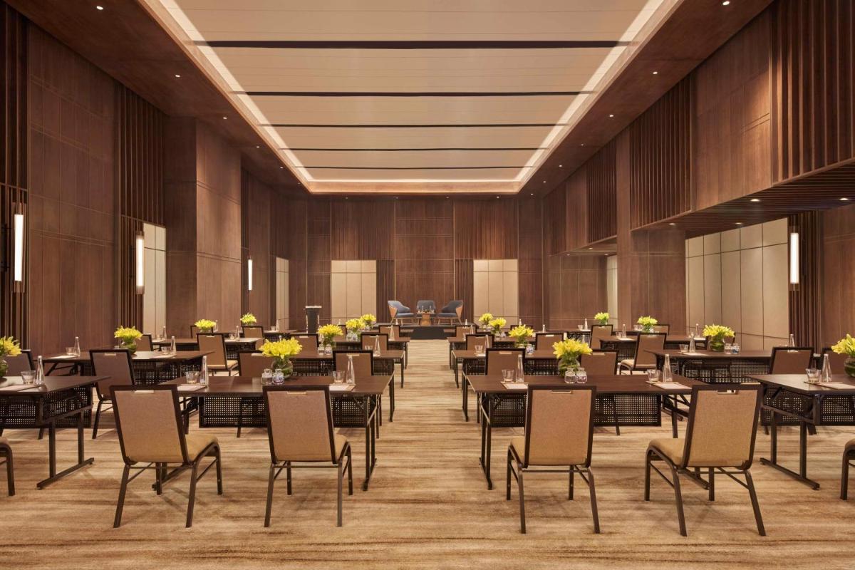 a large banquet hall with tables and chairs at Hilton Gurugram Baani City Centre in Gurgaon