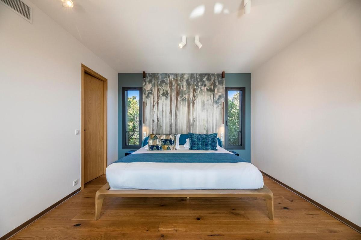 Un ou plusieurs lits dans un hébergement de l'établissement Hôtel & Spa Version Maquis Citadelle