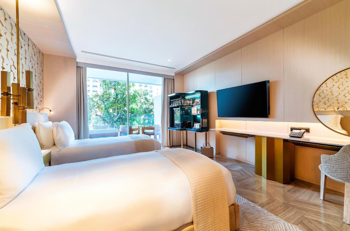 a hotel room with a large bed and a television at FIVE Palm Jumeirah Dubai in Dubai