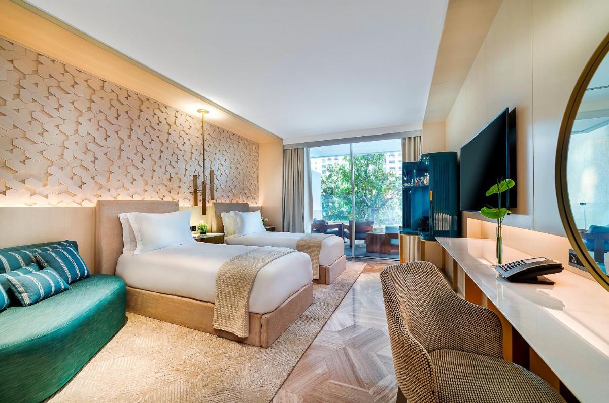 a hotel room with two beds and a desk at FIVE Palm Jumeirah Dubai in Dubai