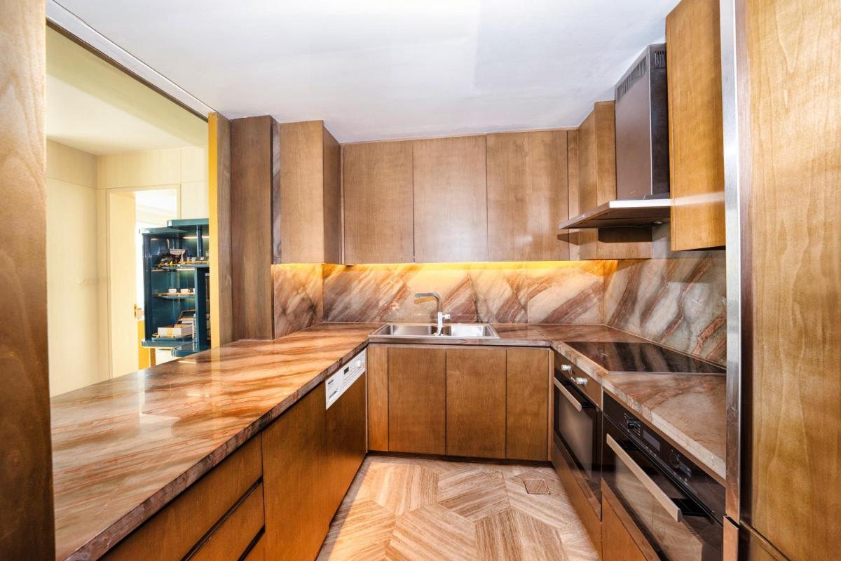 a kitchen with wooden cabinets and a sink at FIVE Palm Jumeirah Dubai in Dubai