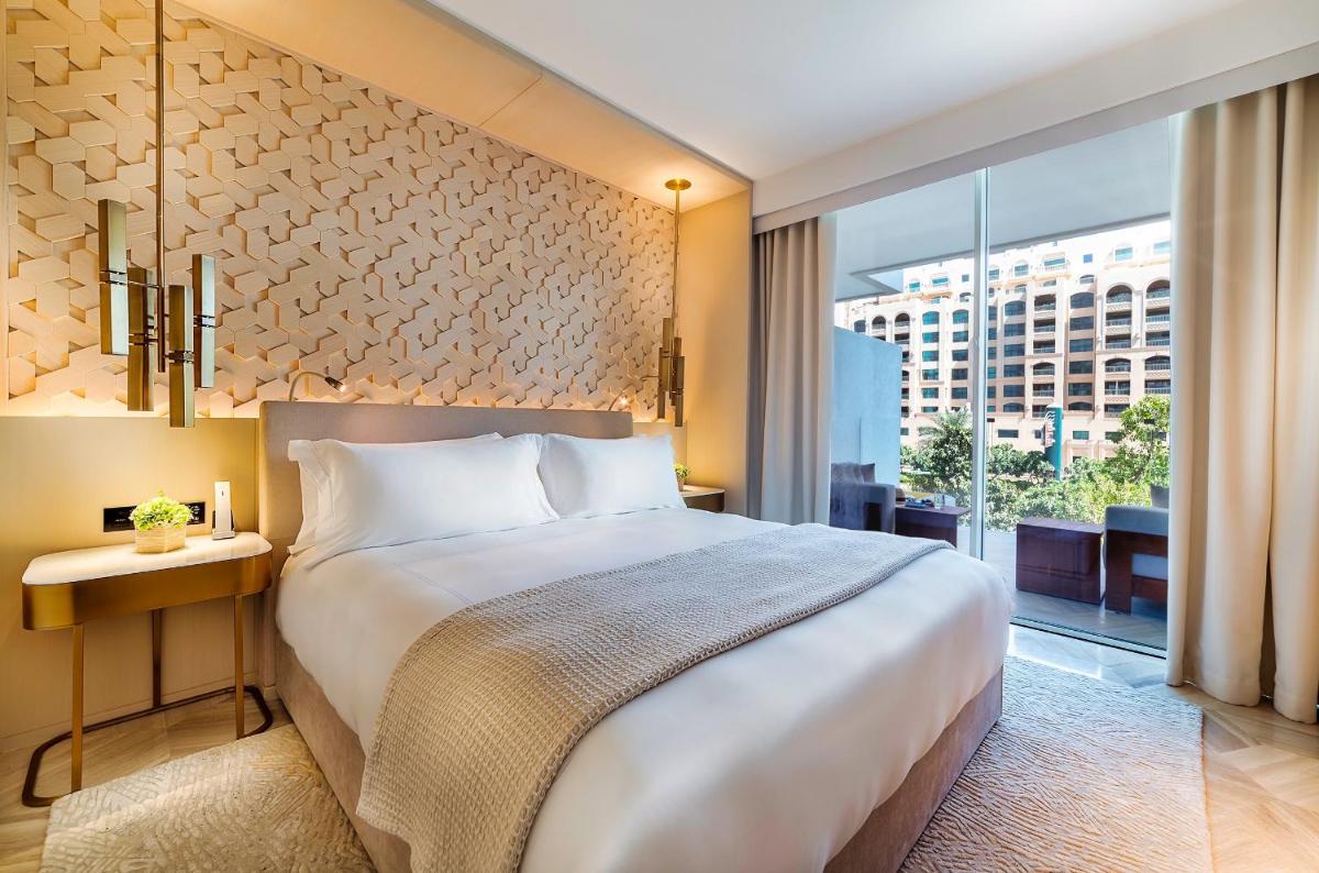 a hotel room with a bed and a large window at FIVE Palm Jumeirah Dubai in Dubai