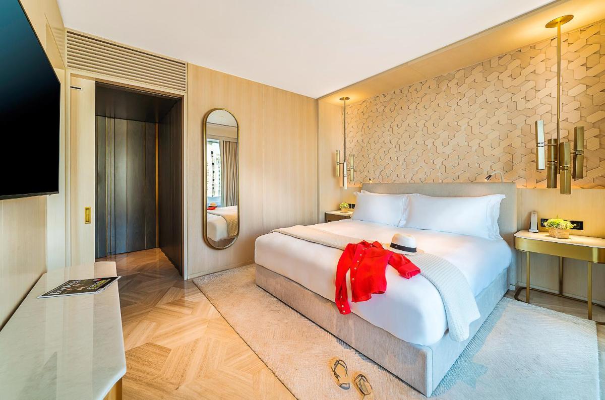 a bedroom with a large white bed with a red bow on it at FIVE Palm Jumeirah Dubai in Dubai