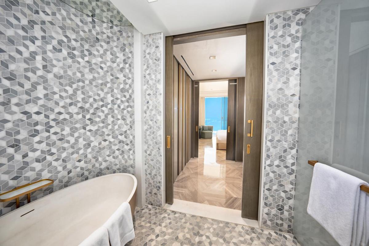 a bathroom with a tub and a walk in shower at FIVE Palm Jumeirah Dubai in Dubai