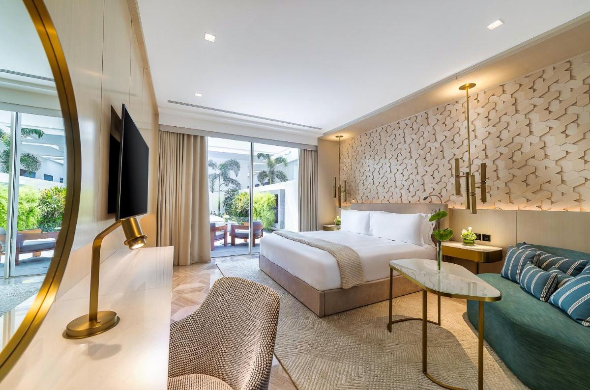 a hotel room with a bed and a couch at FIVE Palm Jumeirah Dubai in Dubai