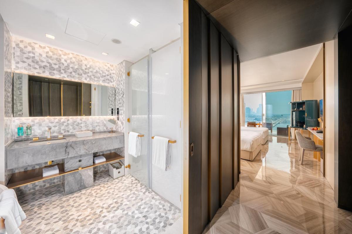 a bathroom with a sink and a large mirror at FIVE Palm Jumeirah Dubai in Dubai