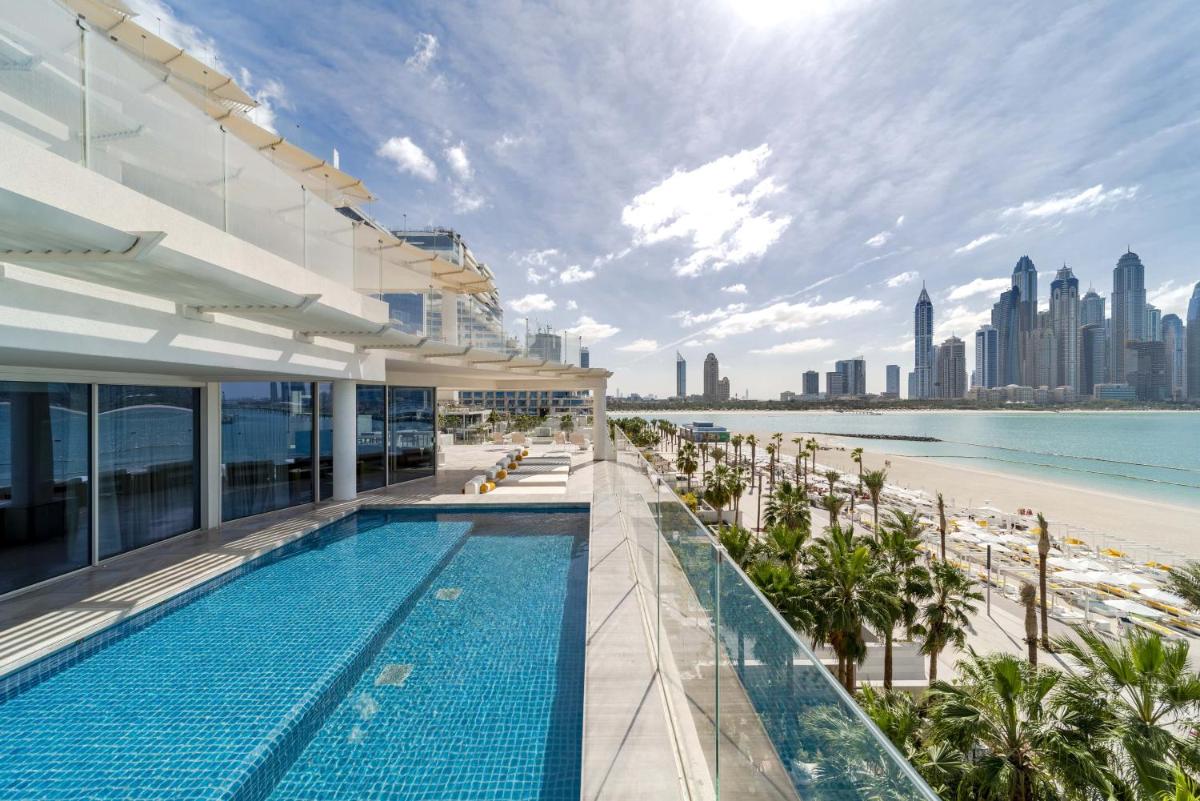 a swimming pool on the roof of a building with a beach at FIVE Palm Jumeirah Dubai in Dubai