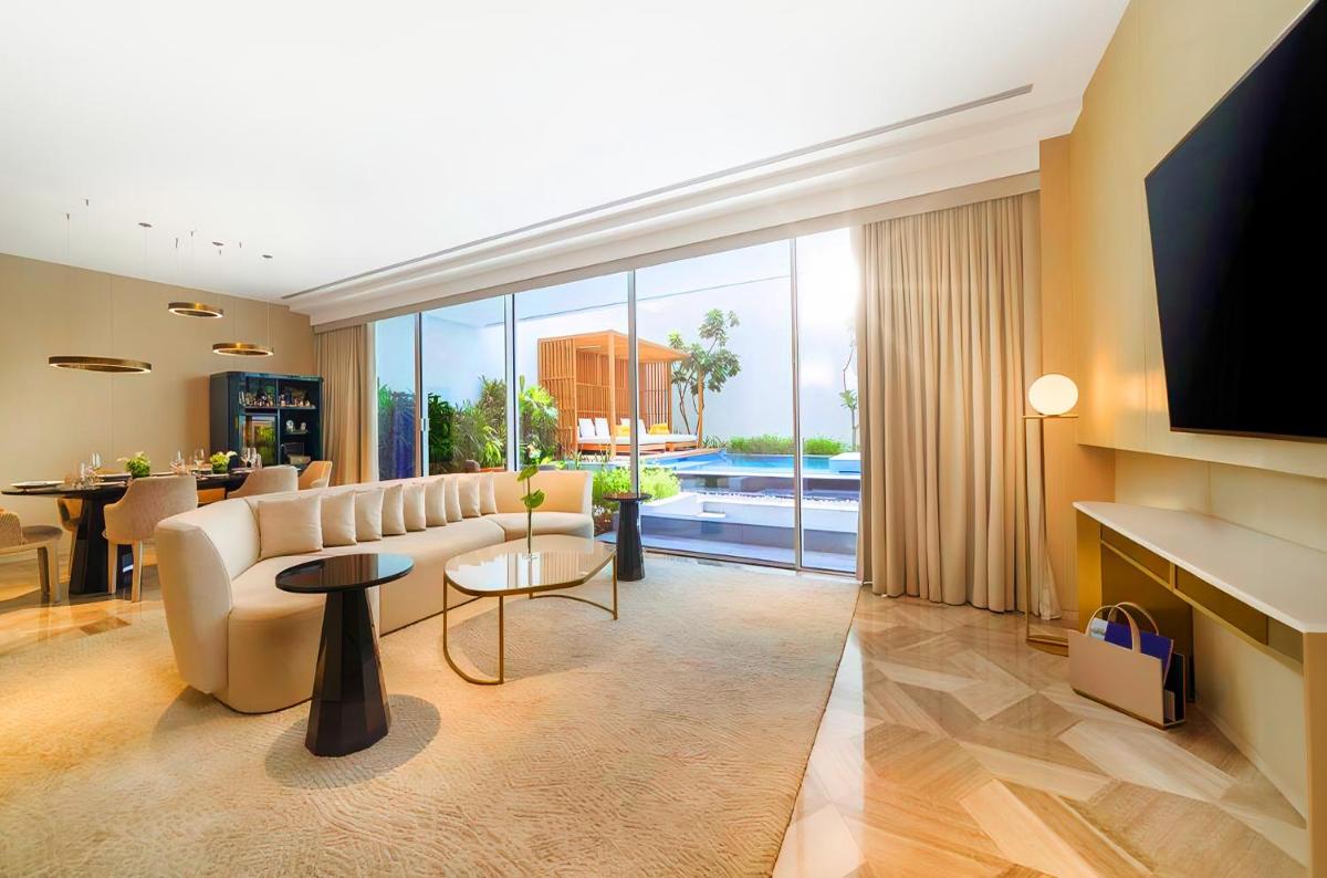 a living room with a couch and a television at FIVE Palm Jumeirah Dubai in Dubai