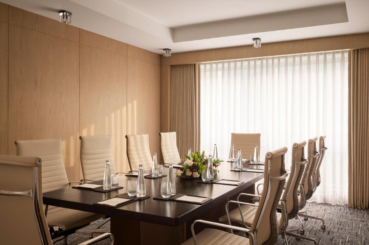 a conference room with a long table and chairs at Grand Hyatt Mumbai Hotel and Residences in Mumbai