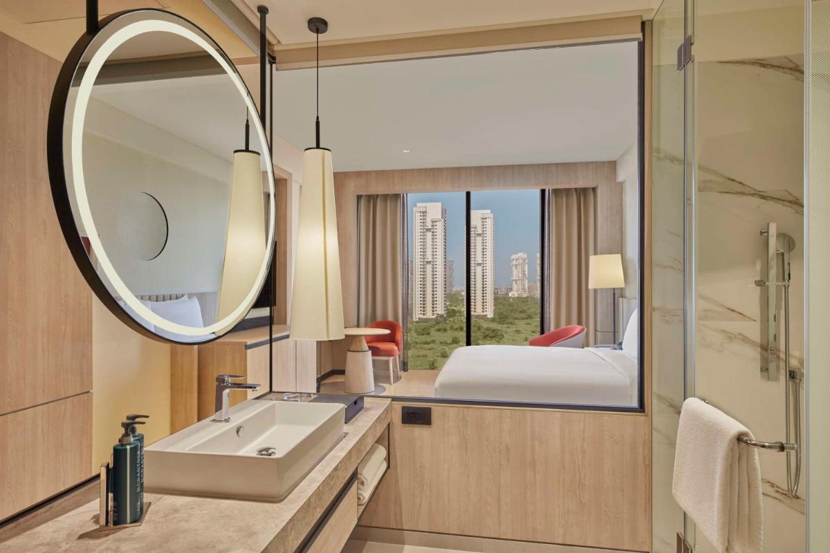 a bathroom with a sink and a mirror at Hilton Gurugram Baani City Centre in Gurgaon
