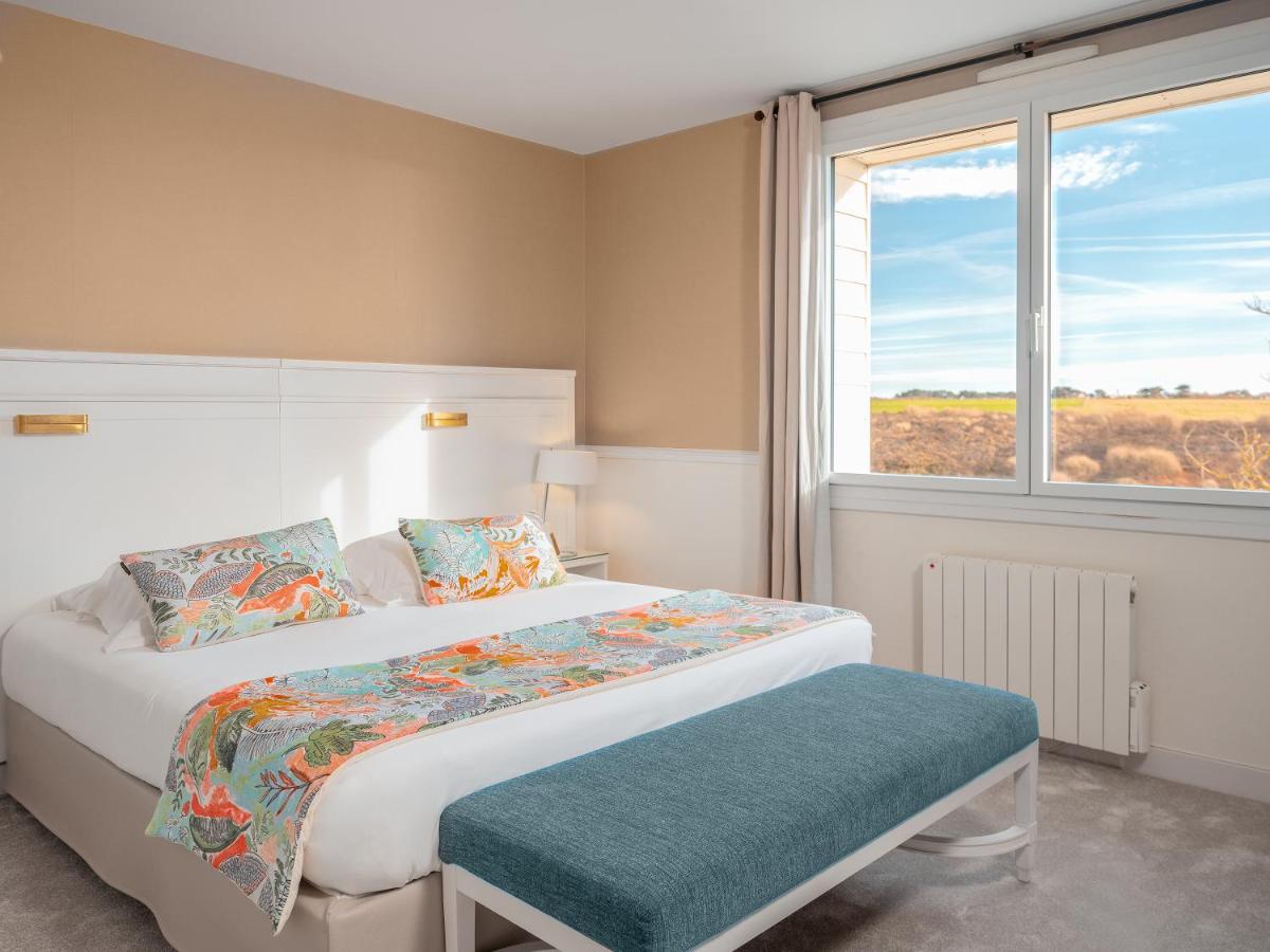 Un ou plusieurs lits dans un hébergement de l'établissement Castel Clara Thalasso & Spa