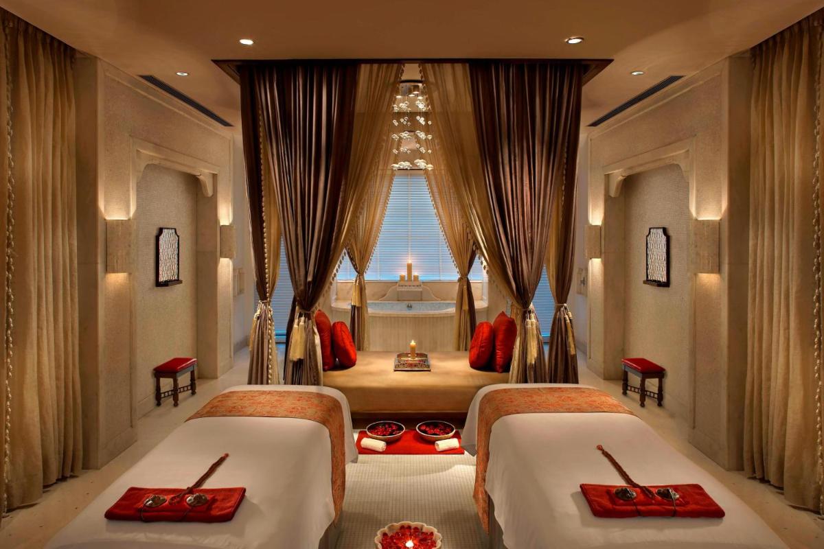 a bedroom with two beds and a window at ITC Mughal, A Luxury Collection Resort & Spa, Agra in Agra
