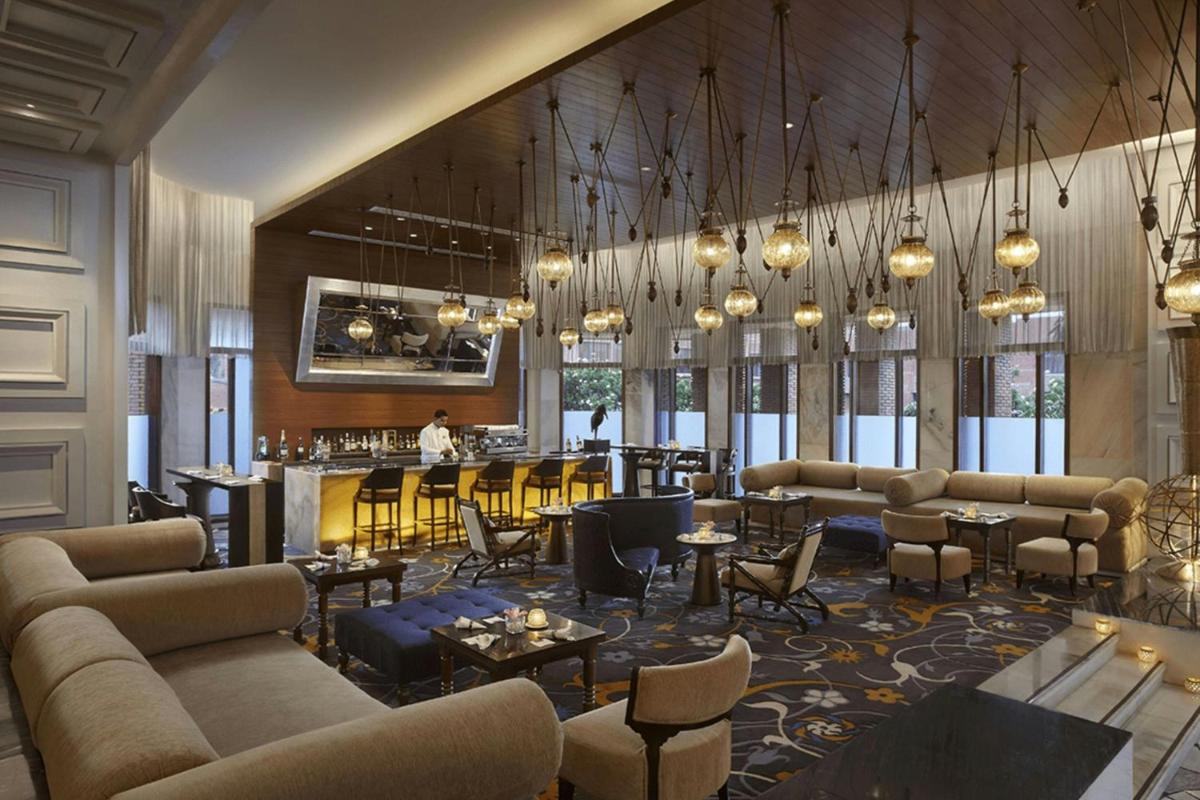 a lobby with couches and tables and a bar at ITC Mughal, A Luxury Collection Resort & Spa, Agra in Agra