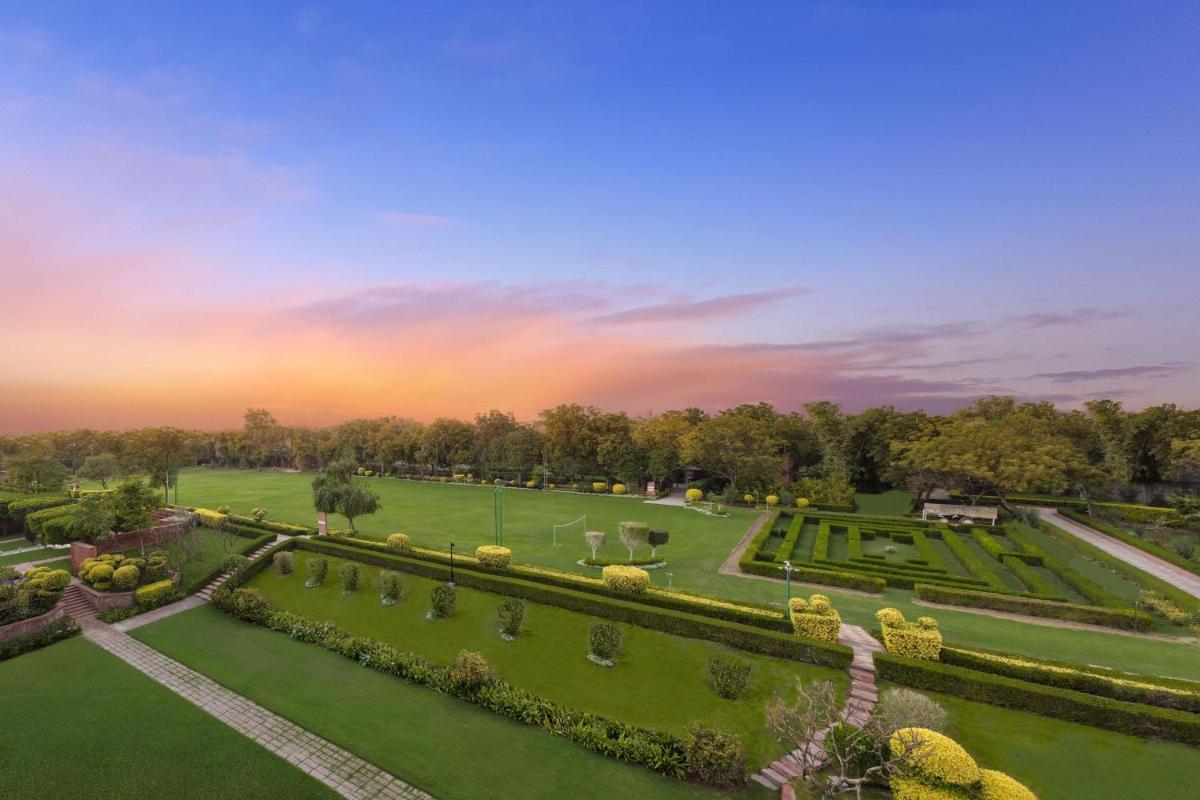 an aerial view of a garden at sunset at ITC Mughal, A Luxury Collection Resort & Spa, Agra in Agra