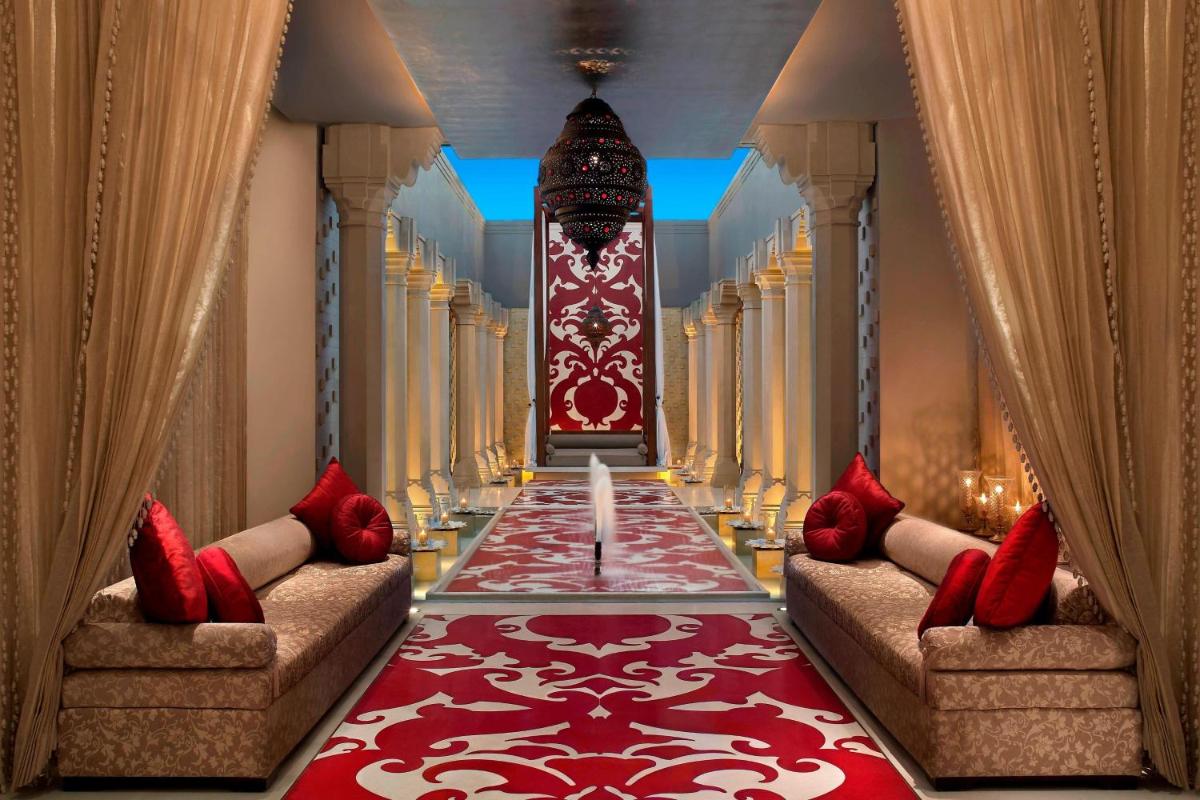 a hallway with two couches and a red carpet at ITC Mughal, A Luxury Collection Resort & Spa, Agra in Agra